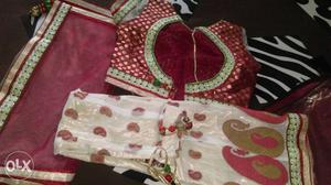 A red and white colour party wear lacha for 