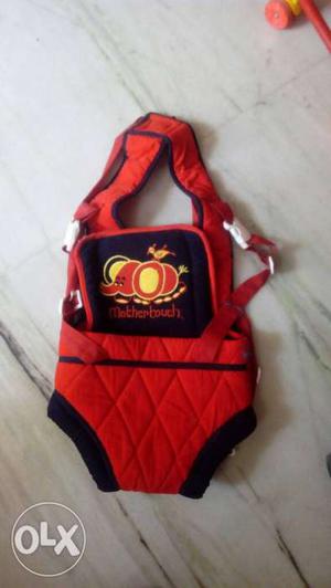 Baby's Yellow, Red, And Black Carrier