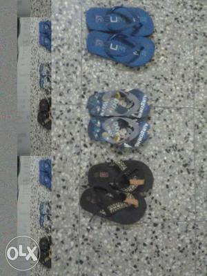 Three Pairs Of Blue, Gray, And Black Flip Flops 25cms