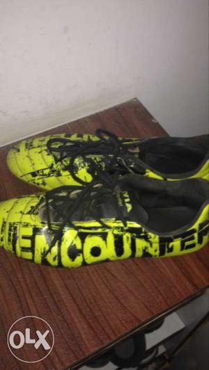 Yellow-and-black Encounter Leather Cleats