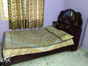 Black Wooden Bed Frame With Brown And Gray Bedspread