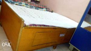 Brown Wooden Bed Frame With White Bed Cover