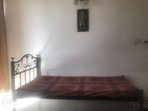Single bed made of wrought iron with mattress and