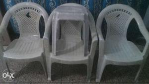Three White Plastic Armchairs with stool