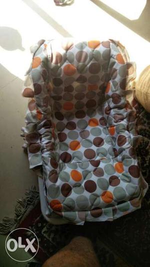 Baby's Green And Orange Car Seat