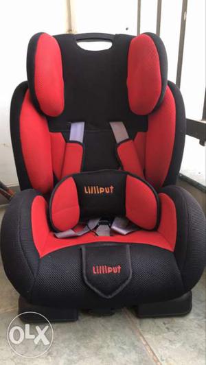 Baby's Red And Black Car Booster Seat