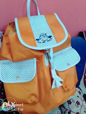 Tangerine color back pack not too old nd hardly