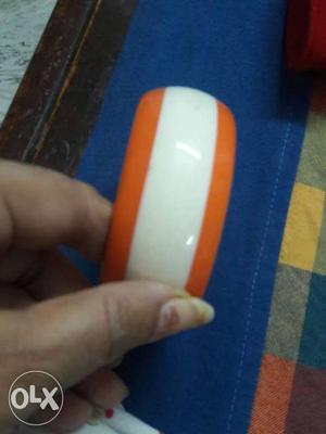 Orange and white color kada (bangle) want to sell