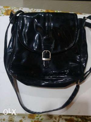 Side bag Made of shiny black raxine Unused bag