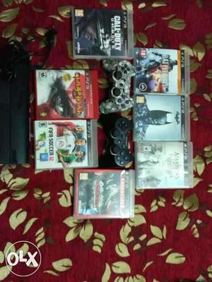 PS3 console with 02 controllers and a pack of