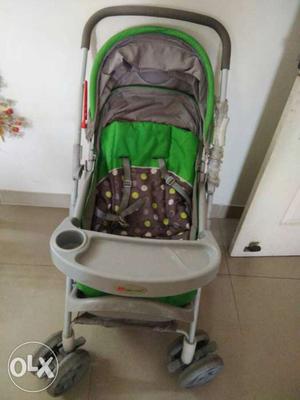 Baby's Black, Gray, And Green Stroller