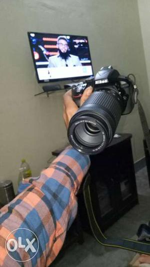 Black Nikon DSLR Camera And Black Flat Screen TV
