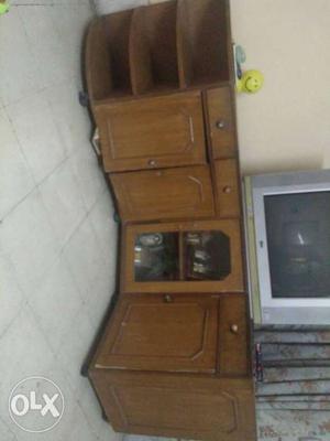 Grey CRT Television On Brown Wooden Corner TV Stand