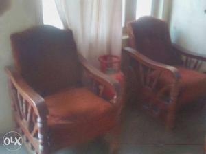 Pair Of Brown Wooden Framed Orange Padded Armchairs