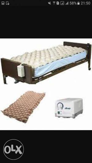White Tufted Mattress Pad And Brown Metal Bed Frame