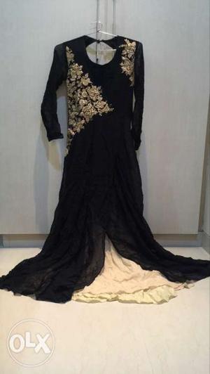 Black gown with gold embroidery, back open,