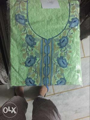 Green And Blue Garment In Pack
