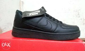 Paired Black Nike Air Force shoe