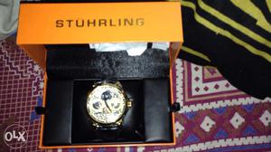 Round Gold Stuhrling Chronograph Watch With Black Leather