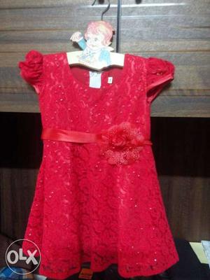 A pretty red dress size 18 ideal for children 1-2