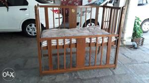 Collapsible wooden cot with mattress and side
