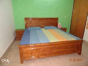 Brown Wooden Bed Frame With Blue And Yellow Bed Sheet And