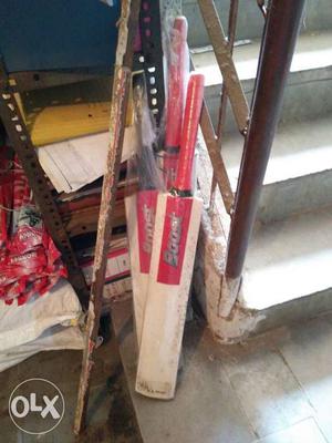 Two Red Handled White Cricket Paddles