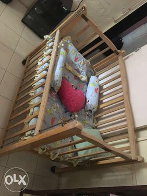 Wooden baby cot with mattress and pillows