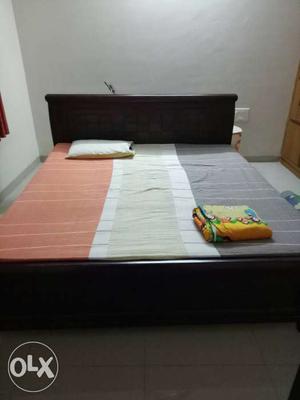 A king size wooden cot in good condition.mattress comes free