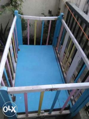 Baby's White, Blue And Pink Wooden Crib