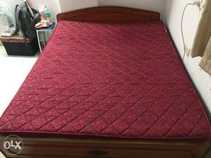 Red Mattress And Brown Wooden Bed Frame