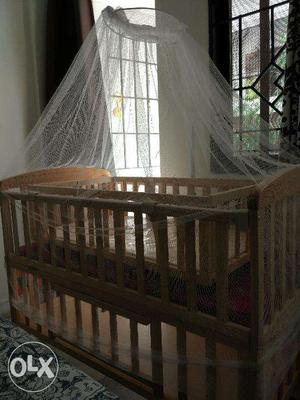 Wooden baby crib with mattress and mosquito net, used very