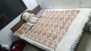 Wooden bed with a new mattress in very good
