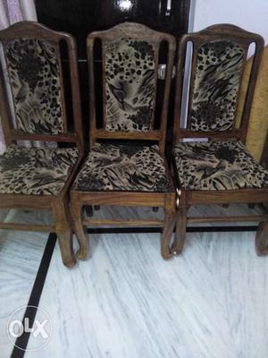 Three Brown Wooden Frame Grey And Black Padded Chairs