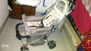 Baby's Gray And Beige Stroller