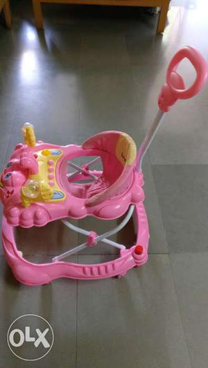 Baby's Pink And Yellow Push Walker