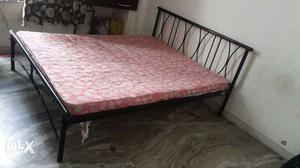 Black Metal Bed Frame And Pink And Brown Mattress
