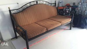 Brown Striped Cushioned Black Wrought Iron Sofa set. 3 + 2
