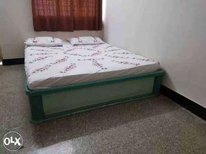 Green bed with White And Pink Mattress