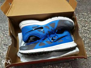 Pair Of Blue-and-black Running Shoes On Box