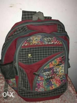 Red, Grey And Black school bag. Less than 1 year.