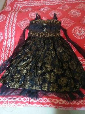 This is a black party wear gown age category - 8