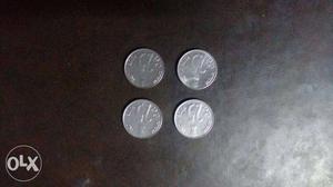 4 silver coins of 25 paise.