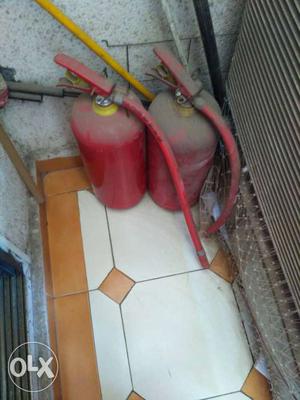 A pair of fire extinguishers up for sale.