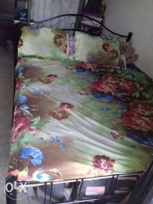 Black Metal Panel Bed With Green And Red Flora Bed Sheet Set