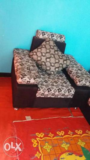Grey And Black Sofa Chair With Throw Pillow