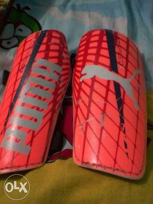 Pink-and-red Puma Shin Guards
