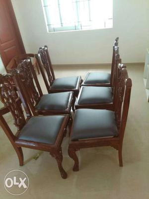 Six Brown Wooden Framed Black Leather Padded Chairs