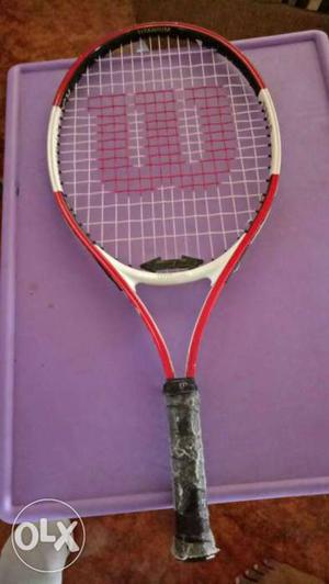 White, Black, And Red Wilson Tennis Racket