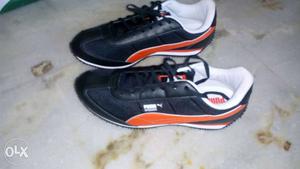 Pair Of Orange And Blue Puma Running Shoes